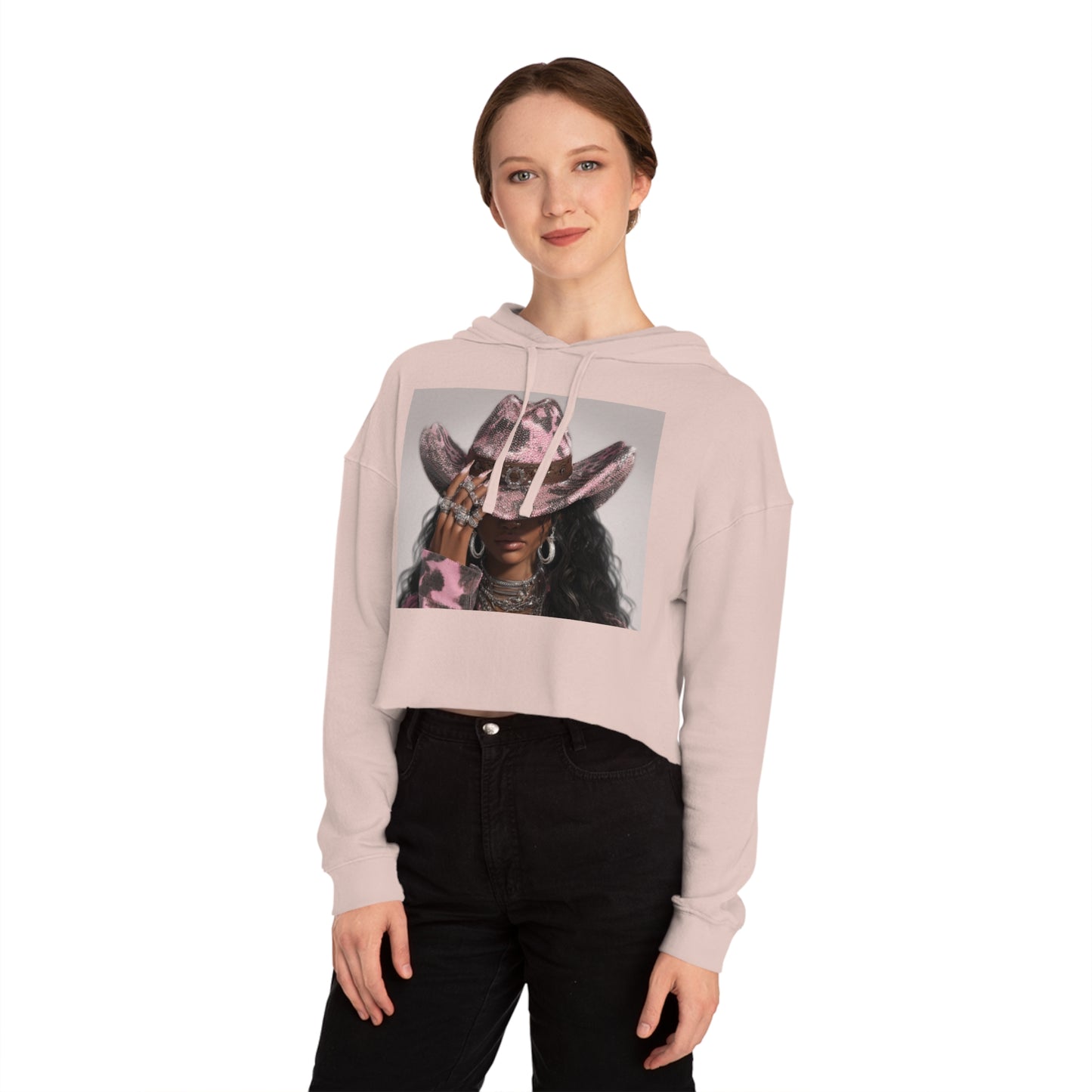 Person wearing a light pink hoodie with a graphic design on a white background